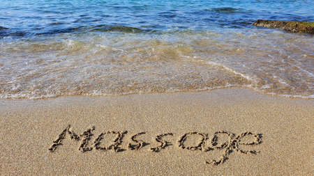 Word Massage written on the sand near the sea.の写真素材