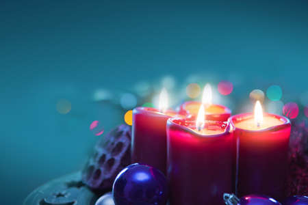 Four red candles for Advent. Christmas background.