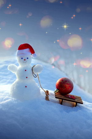 Christmas background with snowman and gifts stand in white snow.の写真素材