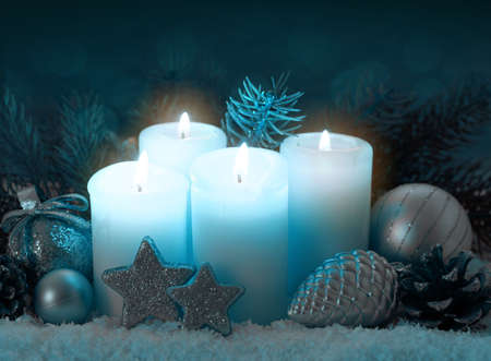 Four white burning advent candles. Christmas card.の写真素材