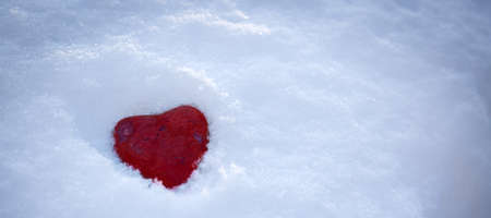 Valentines day background with love stone heart on white snow.の写真素材