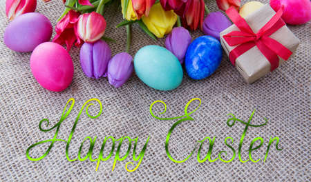 Happy Easter background with colorful eggs and tulips.の写真素材