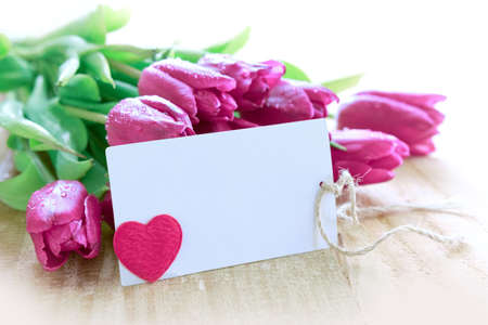 Happy Mothers Day card with purple tulips on wood background.の写真素材