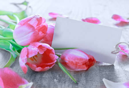 Happy Mothers Day card with pink tulips on wood background.の写真素材