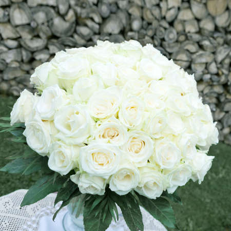Bouquet of white roses in a glass vase on grey background.の写真素材