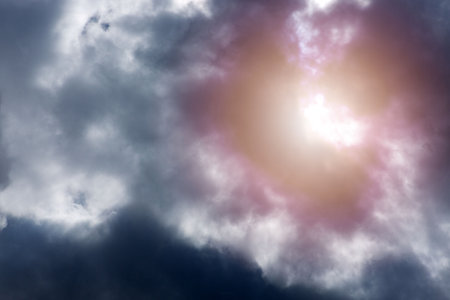 Blue sky with sun and beautiful gray clouds.の写真素材
