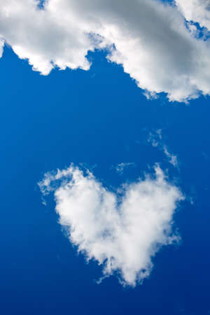 White shape heart in the blue sky background.の写真素材