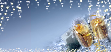 Happy new year greeting card with two champagne glasses and lights.の写真素材