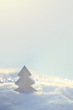 Christmas tree with sunlights stands on white snowの写真素材