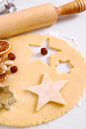 Dough for Christmas cookies and ingredients for baking .の写真素材