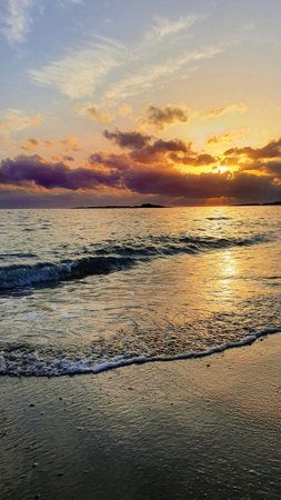 Sunset sky over sea in the evening with colorful clouds and warm sunlight.の写真素材