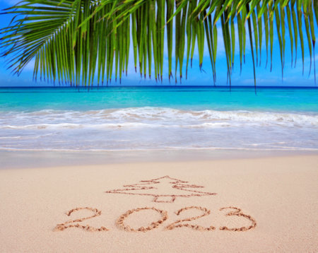 New Year 2023 Inscription written in the white Caribbean sand.の写真素材