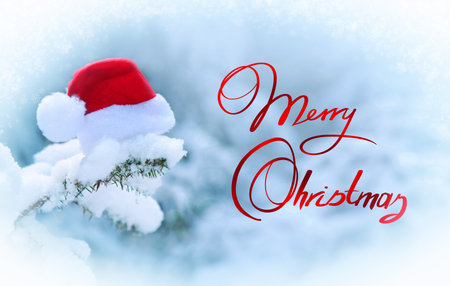 New Year background with Merry Christmas text and red Santa hat .の写真素材