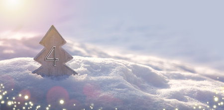 Fourth Advent. Christmas background with fir tree and lights on snow.の写真素材