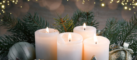 Four Advent candles with Christmas decorations isolated on blur background.の写真素材