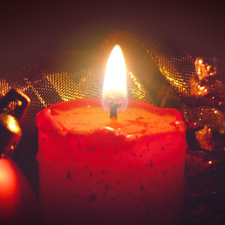 Red Advent candle with Christmas decorations isolated on blur background.の写真素材