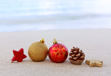 Merry Christmas background with red decorations on Caribbean beach.の写真素材