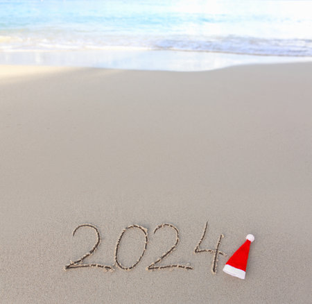 Happy New Year 2024 text on the sea beach.の写真素材