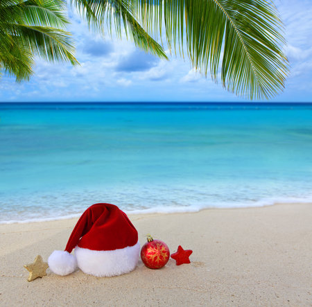 Santa hat and decorations on the white Caribbean sand.の写真素材