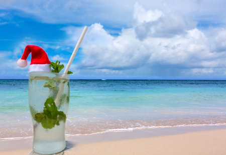 Beach cocktail with Santa Hat on Caribbean beach.の写真素材