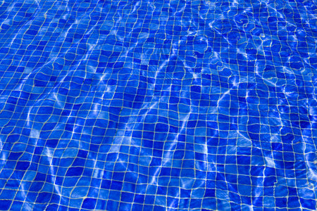 Swimming pool mosaic texture of blue water surface. Top view.の写真素材