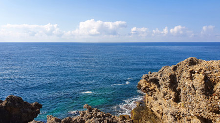 Blue sky and rock beach by the sea .の写真素材