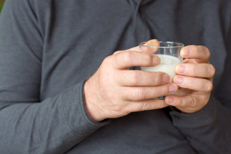 Man holding a glass of milk.の写真素材