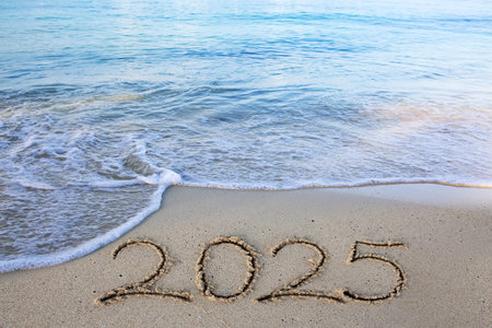 Handwritten inscription 2025 on beautiful white sand beach