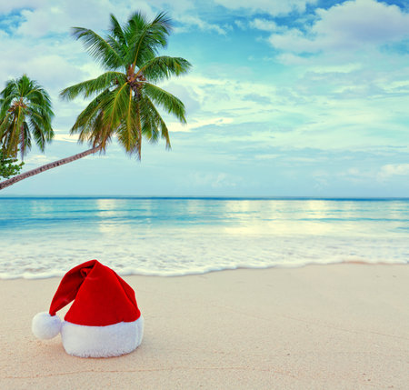 Santa hat on the white Caribbean sand. New Year and Christmas background .の写真素材