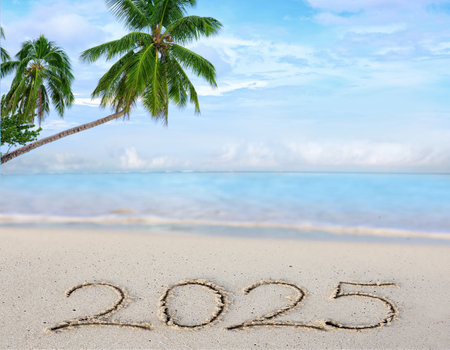 New Year 2025 background with hand written in the white sand.の写真素材