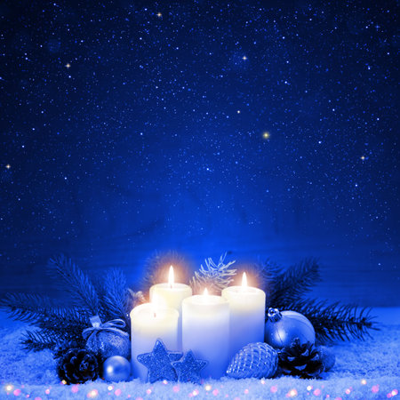 Christmas background with four advent candles and blue sky.の写真素材