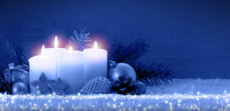 Christmas background with four advent candles and blue sky.の写真素材