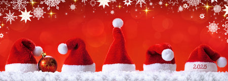 Santa hats isolated on red background. Happy new year.の写真素材