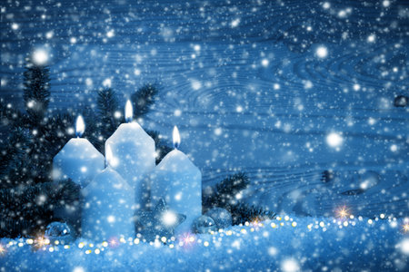 Christmas background with four advent candles and snowfall.の写真素材