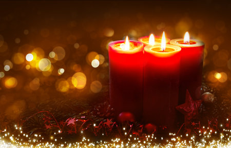 Red Advent candles isolated on blurred background.の写真素材