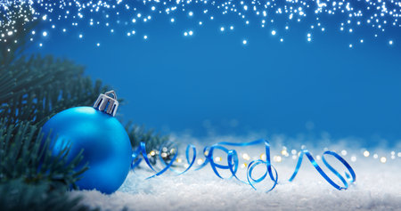 Christmas background with green fir tree branches and blue bauble.の写真素材