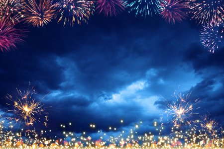 New Year fireworks in the blue night sky.の写真素材