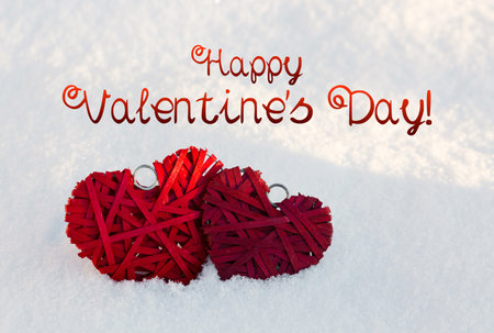 Two red hearts on a background of white snow. Valentine's Dayの写真素材
