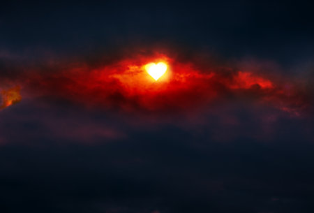 Abstract red background with sunlight and big clouds. Valentines day background with hearts shaped...