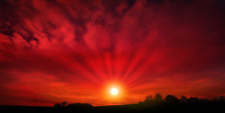 Abstract red background with sunlight and big clouds.