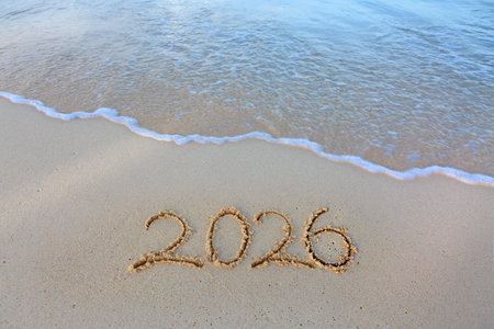 2026 hand written in sand on a beautiful beachの写真素材