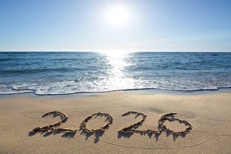 Handwritten inscription 2026 on beautiful white sand beachの写真素材