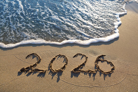 New Year 2026, lettering on the sunny beach sand.の写真素材