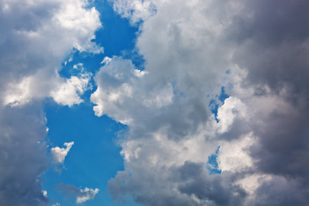 Dramatic gray sky background with sunlight. Summer day.