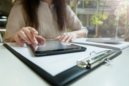 Young woman using tablet while working
