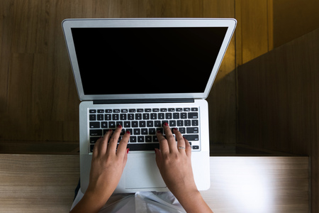Top view of young woman sitting and using laptopの写真素材