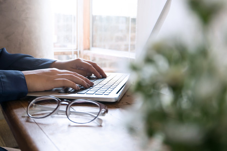 Woman Using Laptop, Searching Web, Browsing information, having workplace at coffee shop cafe
