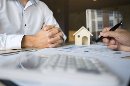 financial inspector making report,insurance agent analyzing about home investment loan at office roomの写真素材