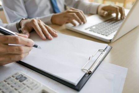 financial inspector making report,insurance agent analyzing about home investment loan at office roomの写真素材