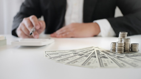 woman using the calculator about investment plan, funds and banking conceptの写真素材